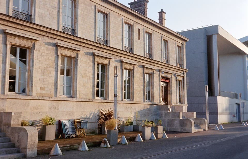 Classic French limestone building with wrought-iron balconettes