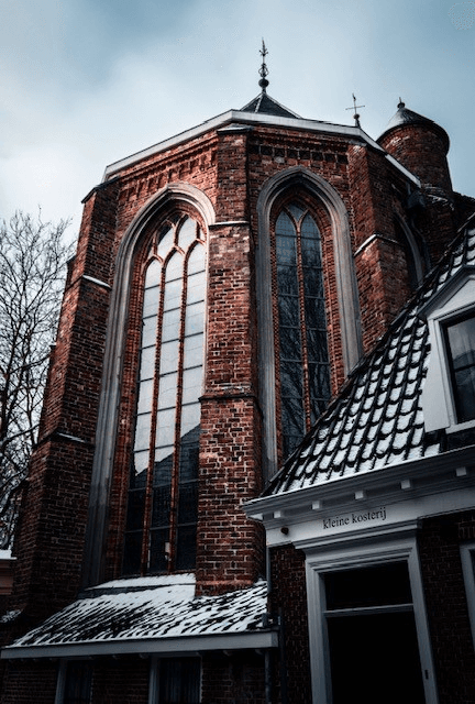 Historic Dutch red-brick architecture with Gothic arched windows